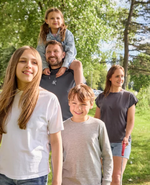 Happy family walking together outdoors on a sunny day at Billing Aquadrome.