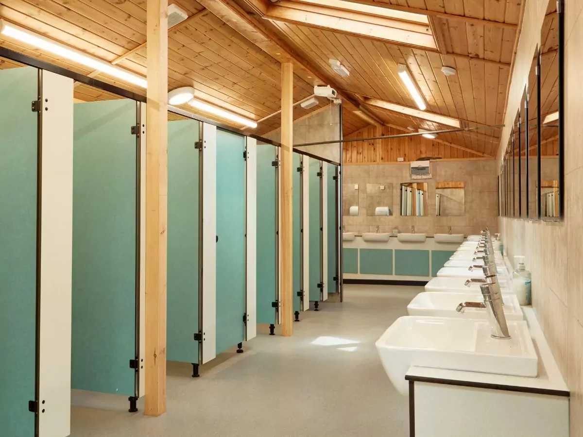 Modern shower and toilet block with clean sinks and private cubicles available for guests at Billing Aquadrome.