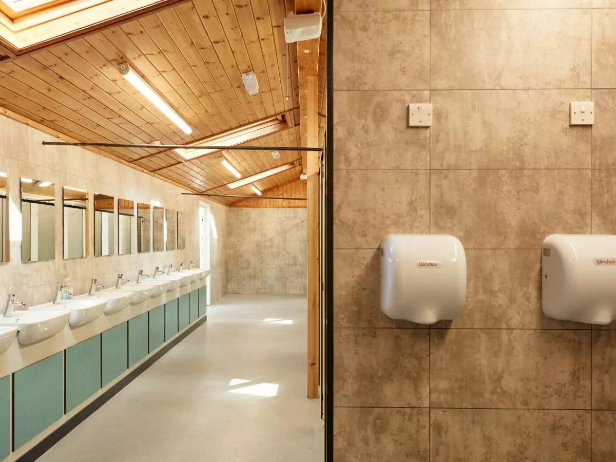 Spacious and modern washroom facilities with sinks, mirrors, and hand dryers for guests at Billing Aquadrome.