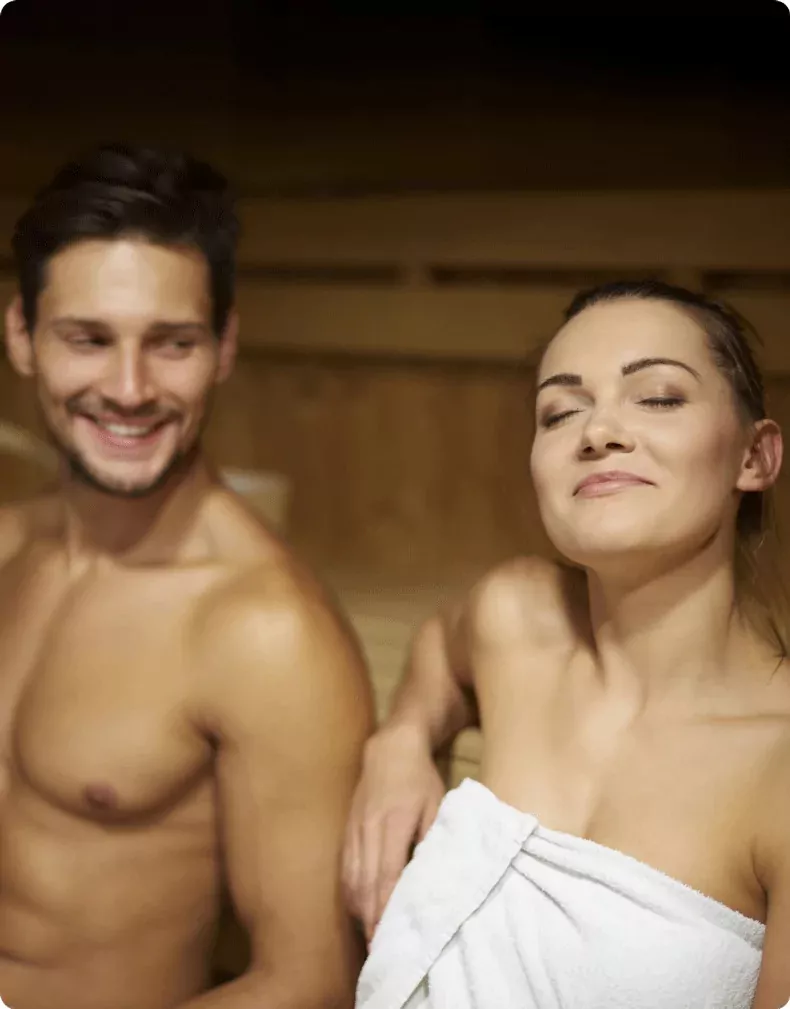 Couple relaxing together in a wooden sauna at Billing Aquadrome.
