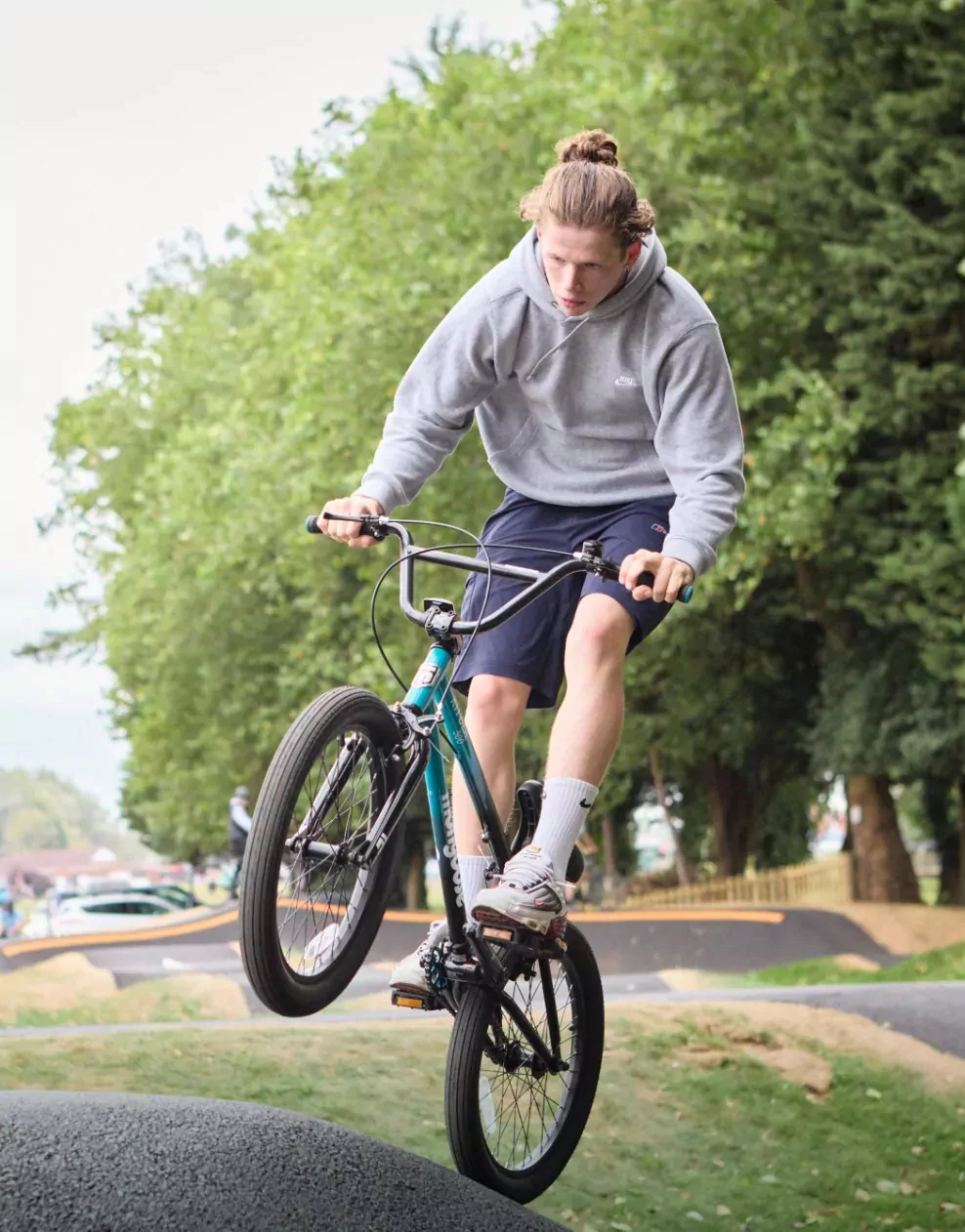 Young man performing a trick on a BMX bike at the outdoor pump track at Billing Aquadrome
