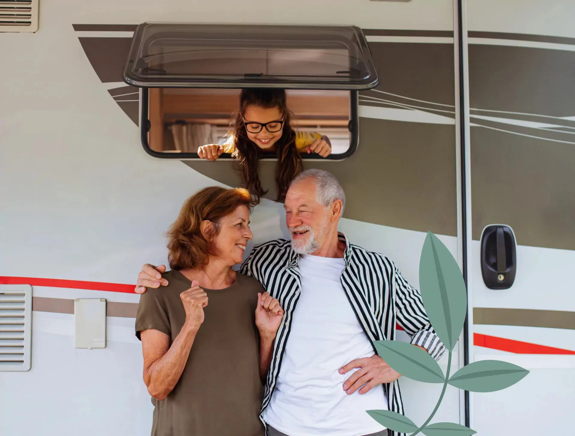 Happy grandparents standing by their caravan with their granddaughter looking out of the window at Billing Aquadrome, Meadow Bay Villages.