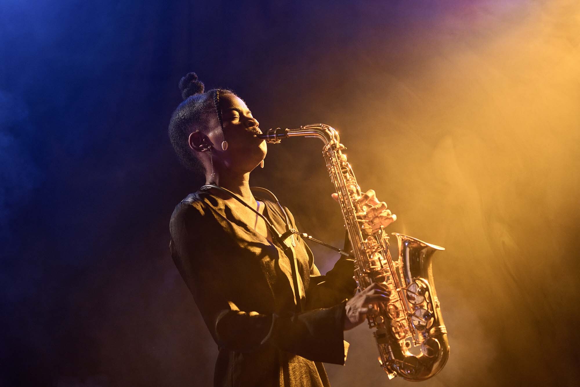 Saxophone player performing under dramatic stage lighting at Meadow Bay Villages – part of the live evening entertainment lineup.