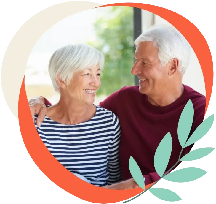 Happy retired couple smiling together, representing the relaxed and friendly lifestyle offered at Meadow Bay Villages.