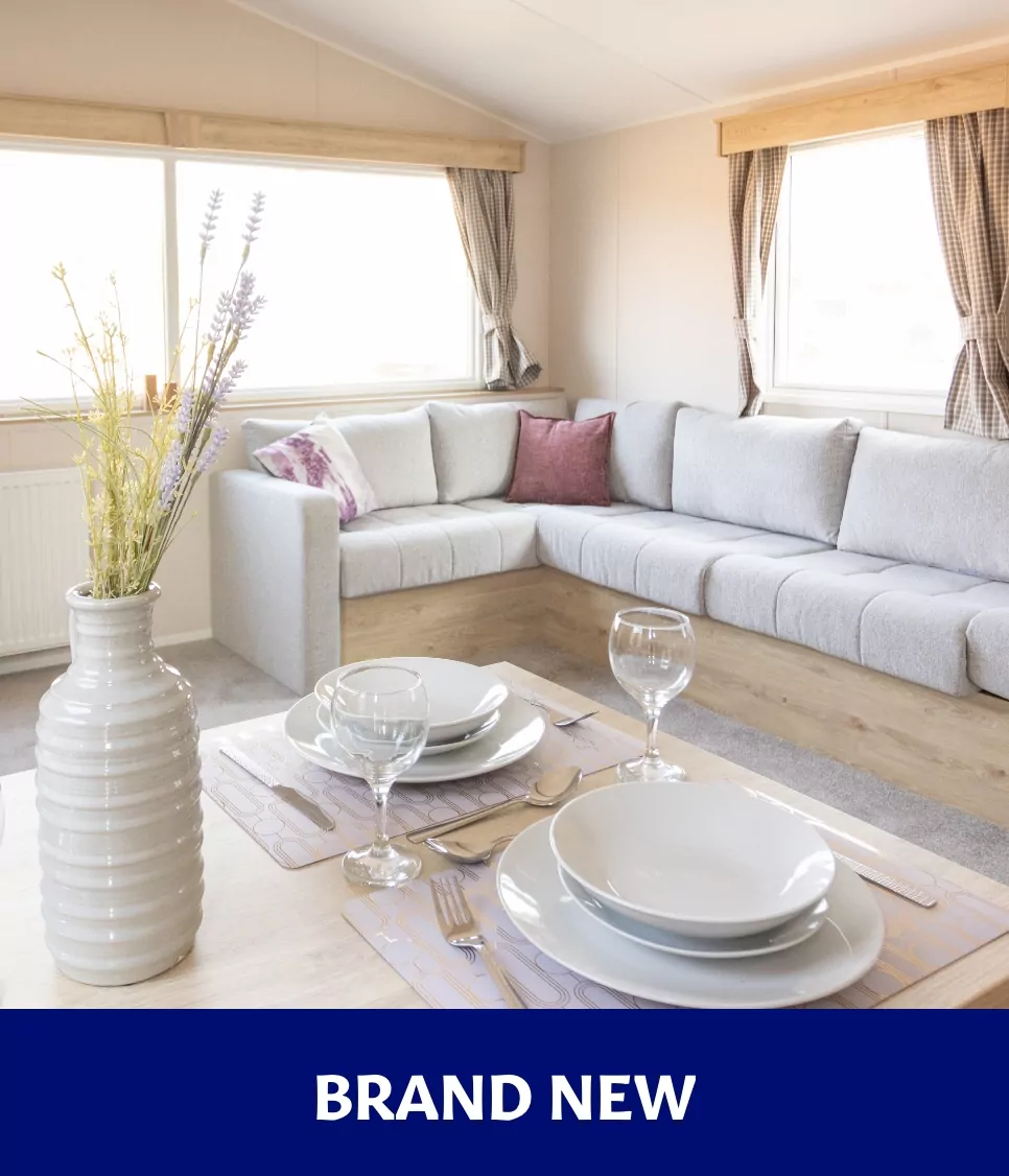 Brand new modern holiday home living and dining area with corner sofa at Billing Aquadrome.