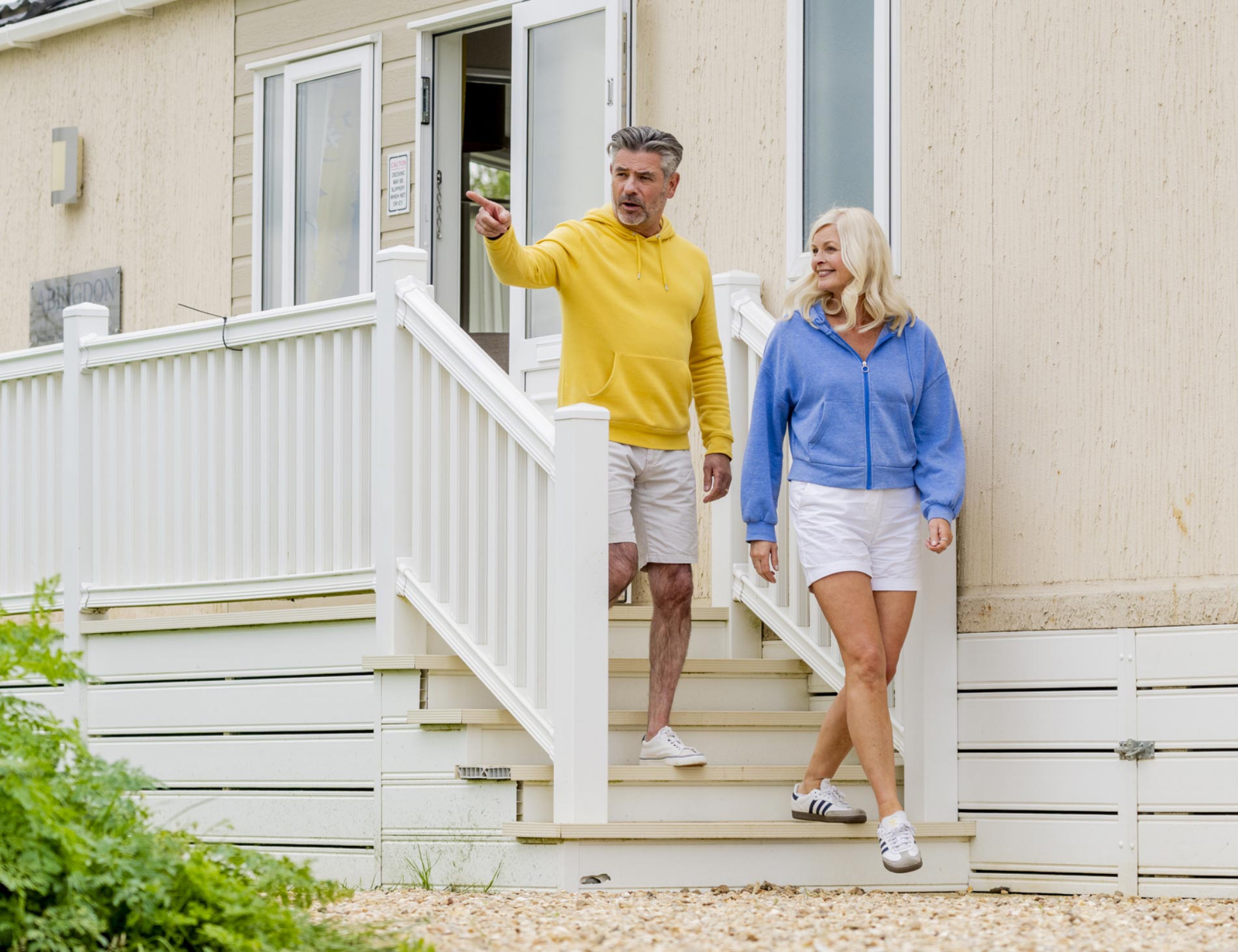 Couple enjoying time outside their holiday home steps at Billing Aquadrome.
