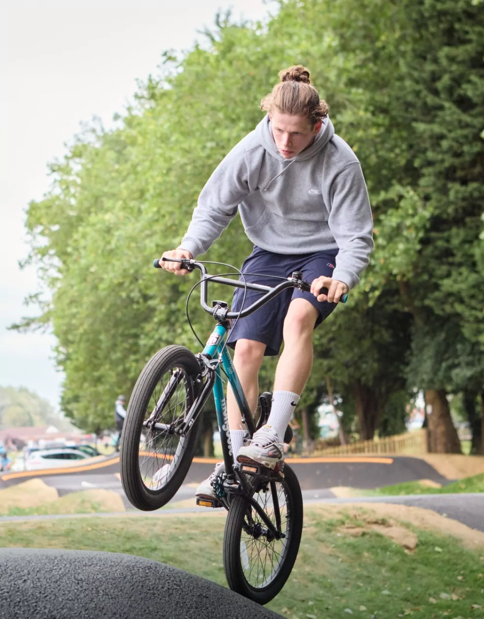 Young rider performing a trick on the outdoor pump track at Billing Aquadrome.