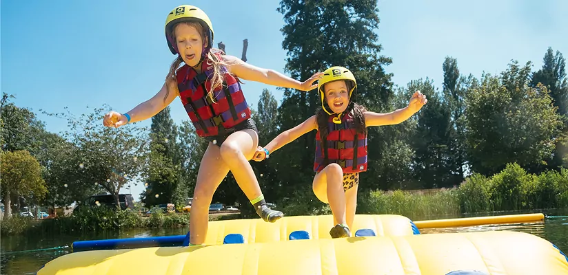 Children enjoying an exciting inflatable water activity at Billing Aquadrome