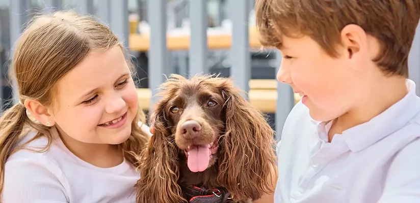 Children smiling with their dog in a welcoming pet-friendly environment at Billing Aquadrome