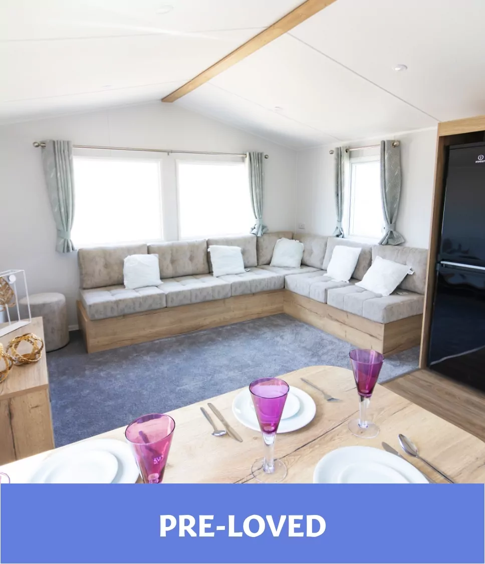 Pre loved holiday lodge interior with corner sofa seating and dining table setup Billing Aquadrome