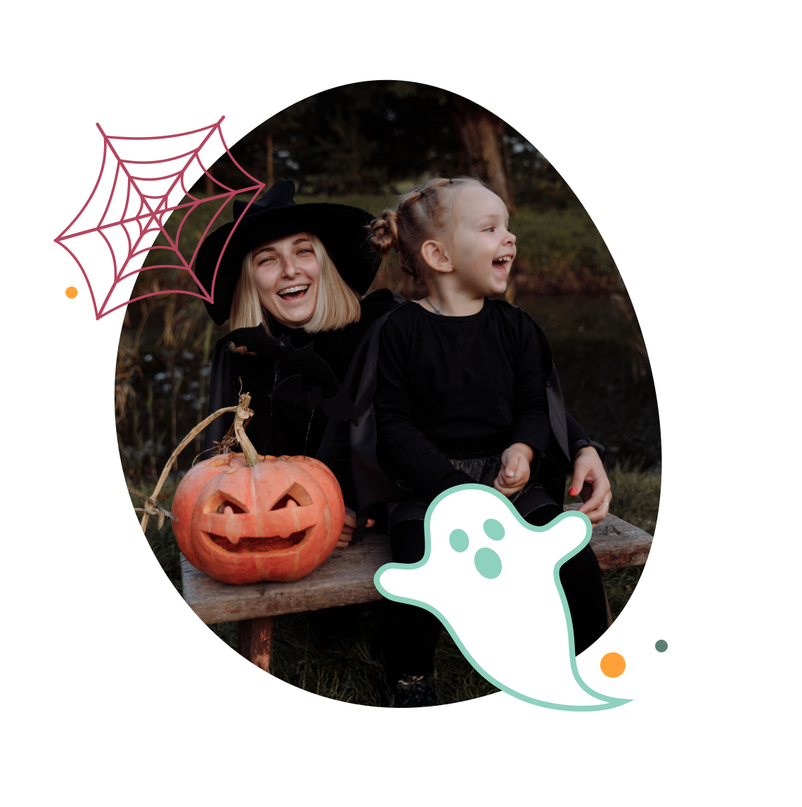 Smiling woman in a witch hat sitting with a child on a wooden bench with a jack-o-lantern at Billing Aquadrome