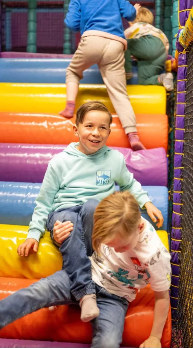 Children having fun together on the colourful soft play slide at Billing Aquadrome.