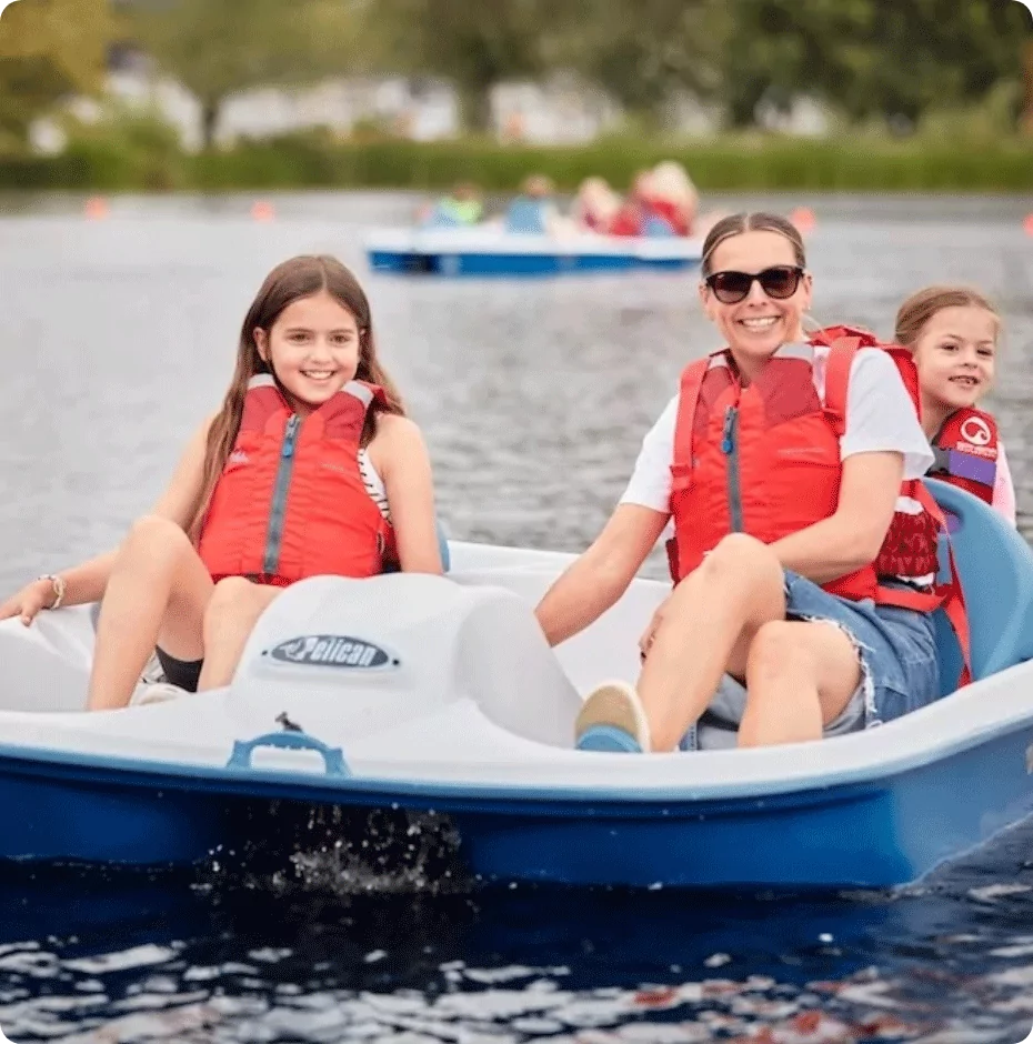 Family enjoying a ride together on a pedalo boat across the lake at Billing Aquadrome.