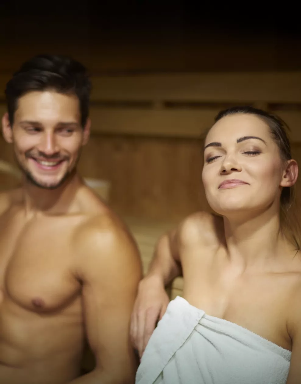 Couple relaxing and unwinding together in a wooden sauna at Billing Aquadrome.