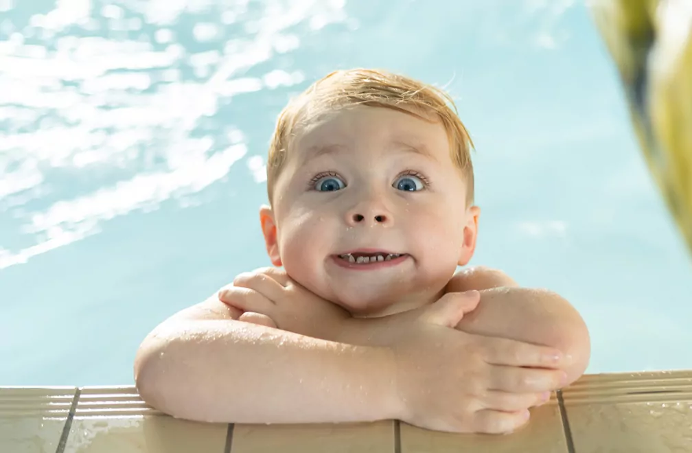 Young boy playing by the poolside during a summer holiday at Billing Aquadrome.