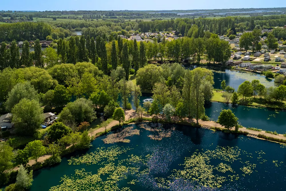 Aerial view showing lakes, greenery and holiday accommodation across the park landscape at Billing Aquadrome
