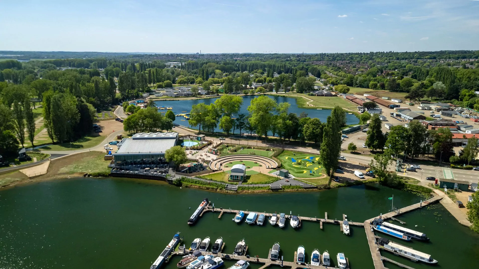 Aerial view of Billing Aquadrome holiday park showing lakes, marina, facilities and surrounding countryside on a sunny day at Billing Aquadrome