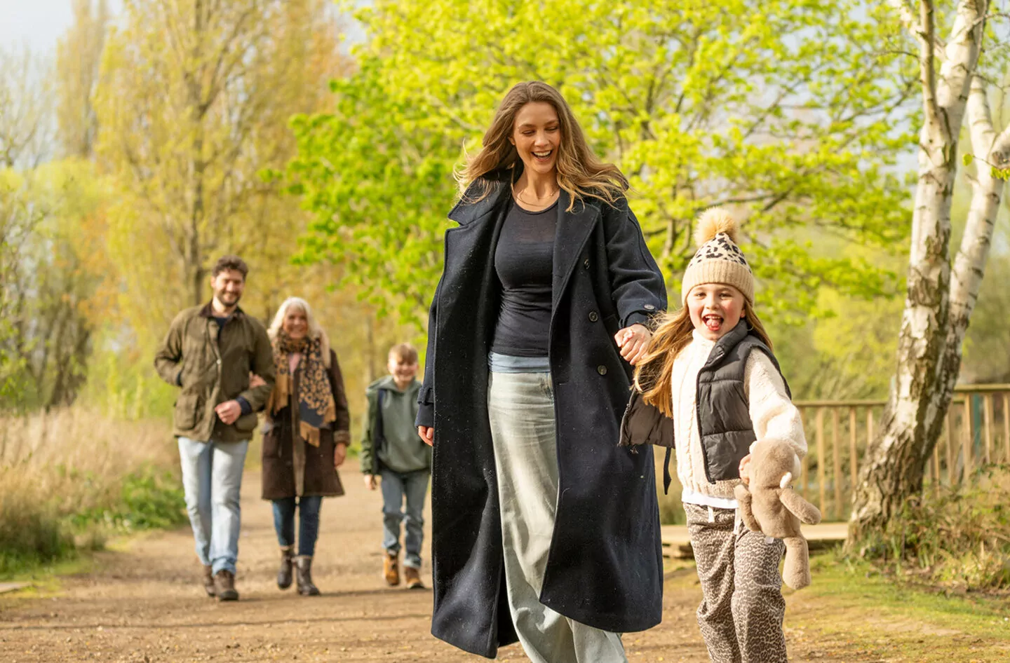 Multi-generational family enjoying a autumn walk together outdoors in the parkland, Billing Aquadrome