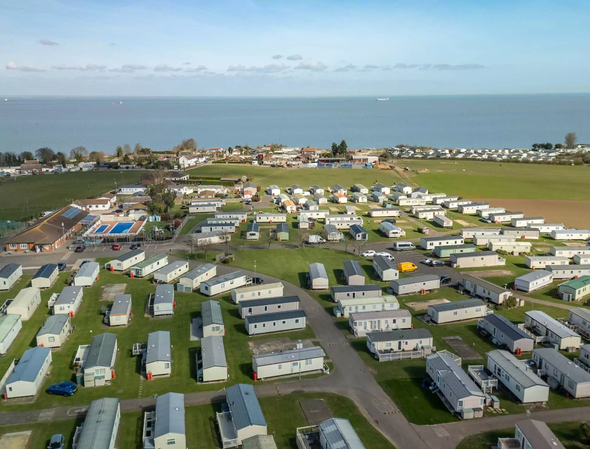 Aerial view of Golden Leas holiday park showing rows of caravans for sale and stunning sea views at Golden Leas.