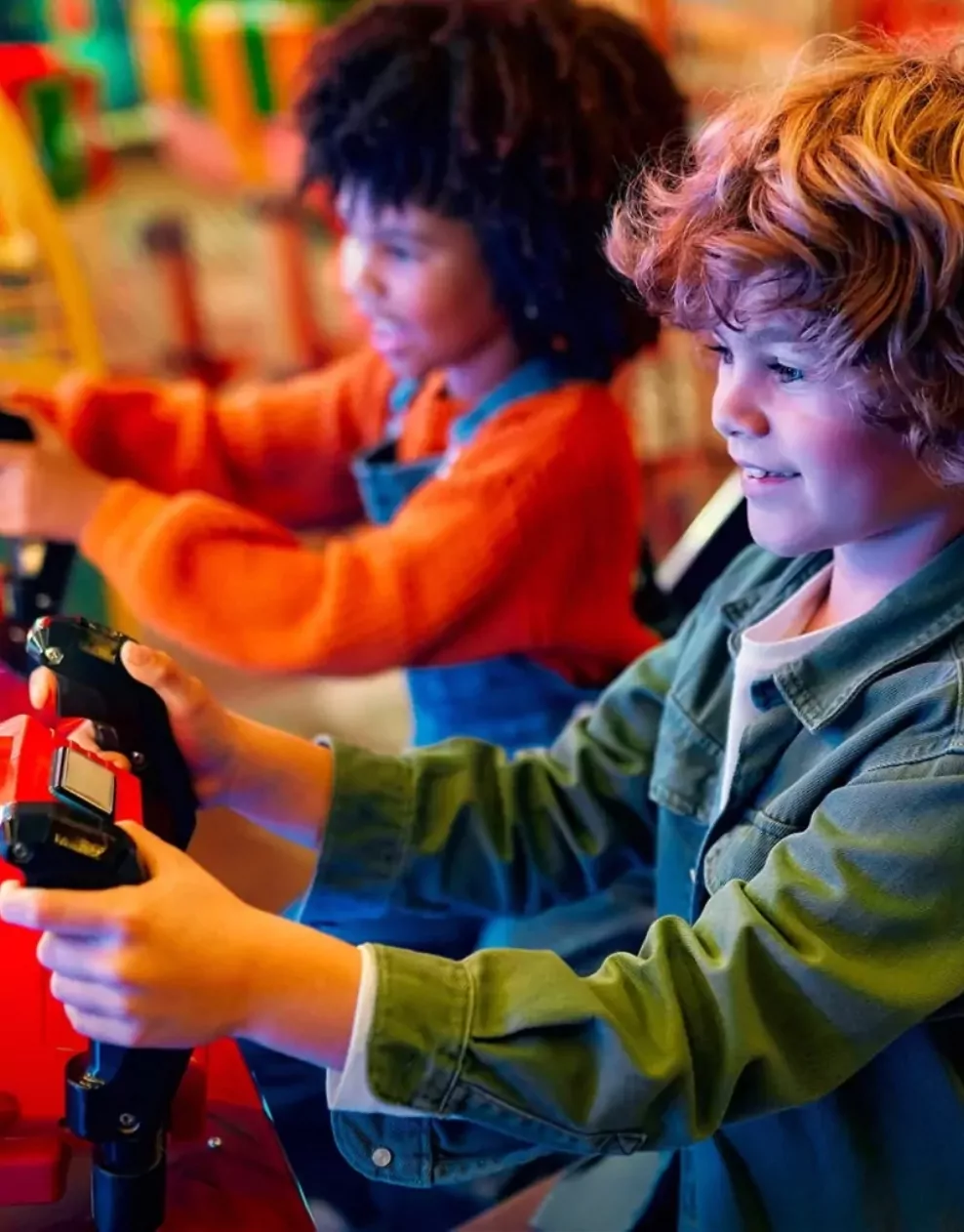 Children playing on racing simulator machines in the amusement arcade at Golden Leas