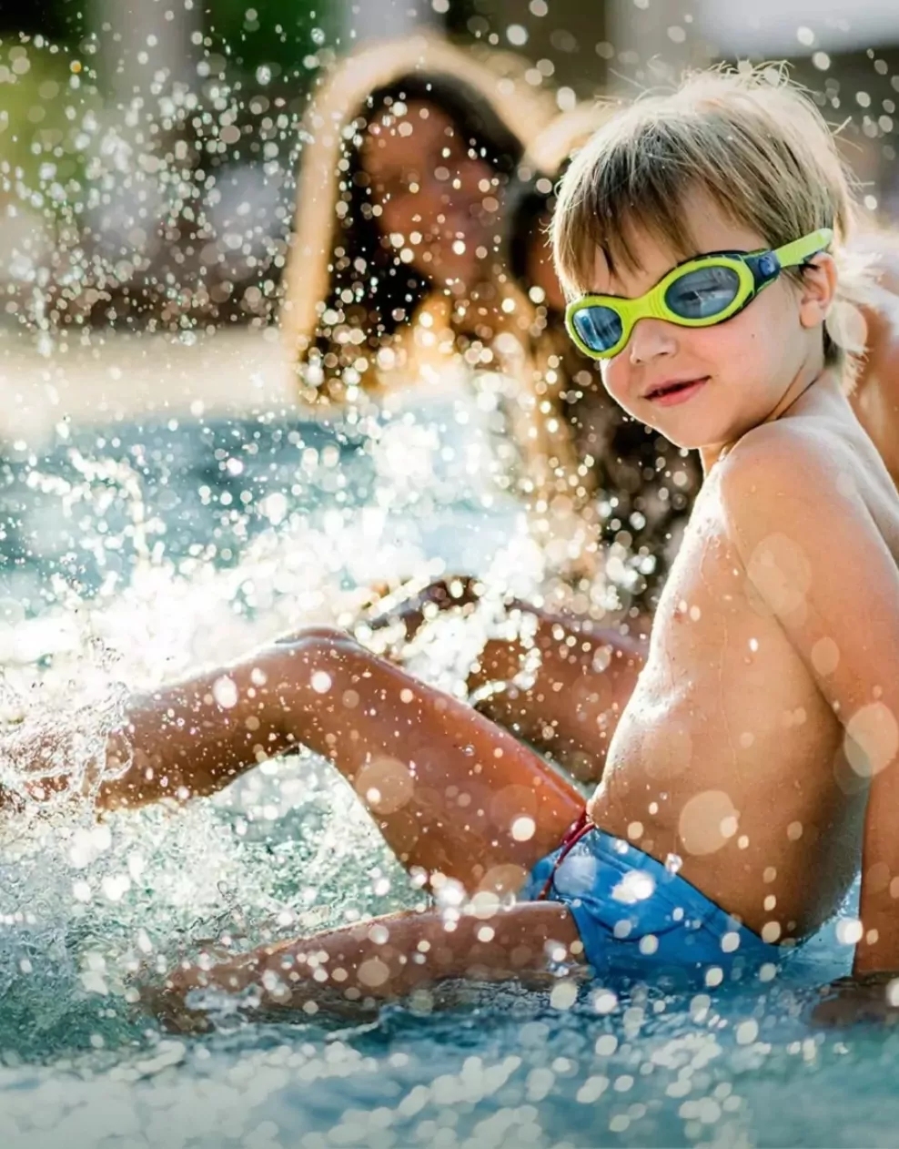 Children splashing and playing in the water at the swimming pool at Golden Leas