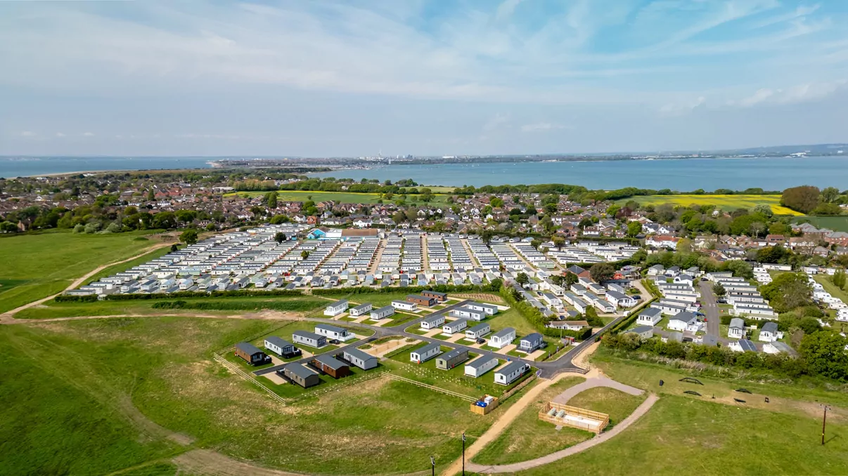 An aerial drone view of the holiday park and caravans overlooking the coastline at Hayling Island