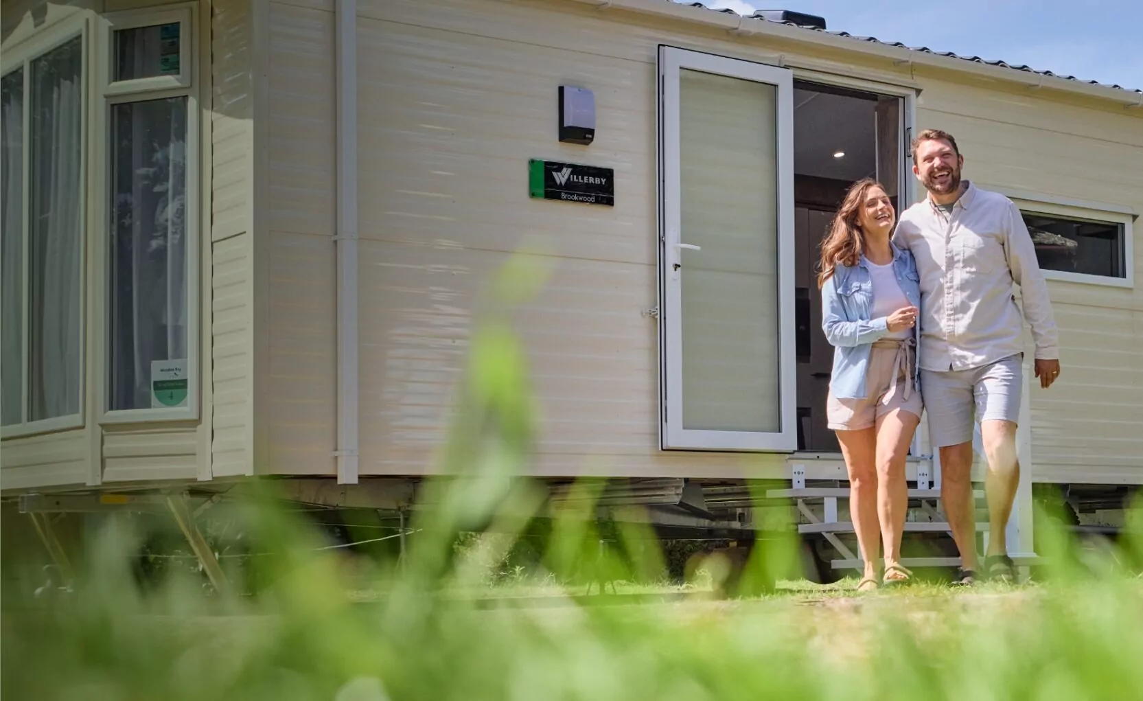 Photos of couple outside of caravan | book uk couples holidays at Hayling Island holiday park in Hampshire