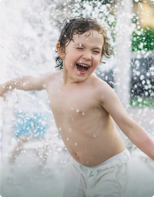 A child playing in water in a pool