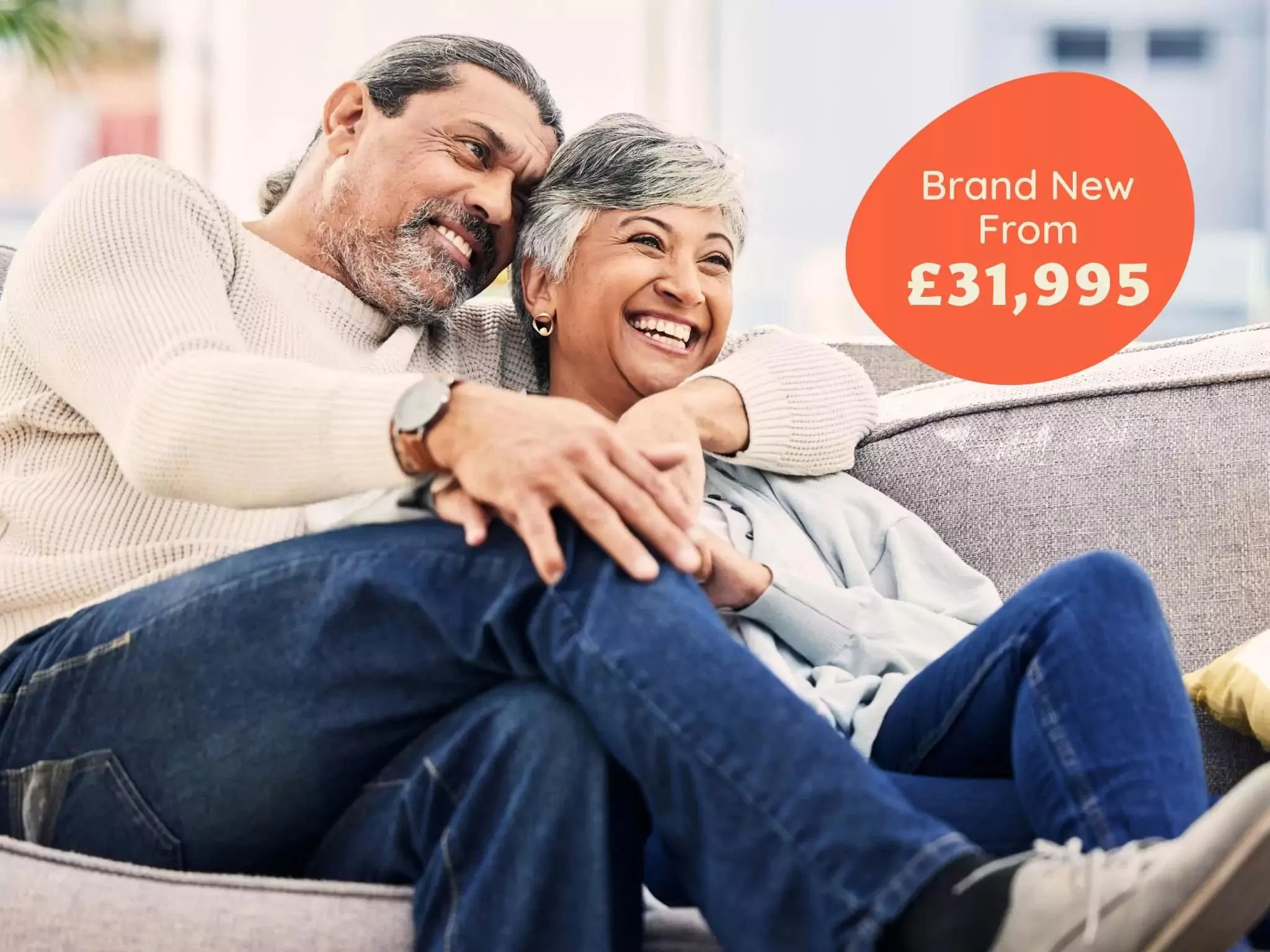 A happy couple relaxing together at home, promoting brand-new holiday home offers on Hayling Island starting from £31,995