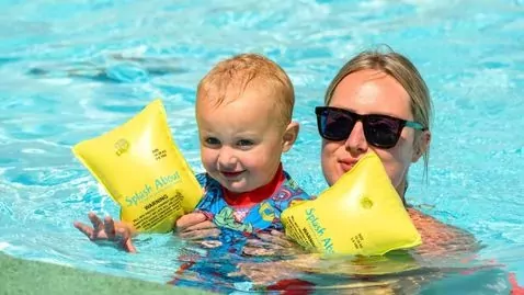 A mother and toddler enjoying a swim together in the outdoor pool on Hayling Island.