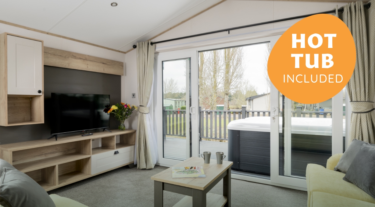 Luxury platinum caravan at Hayling Island with outdoor hot tub and stylish living area.