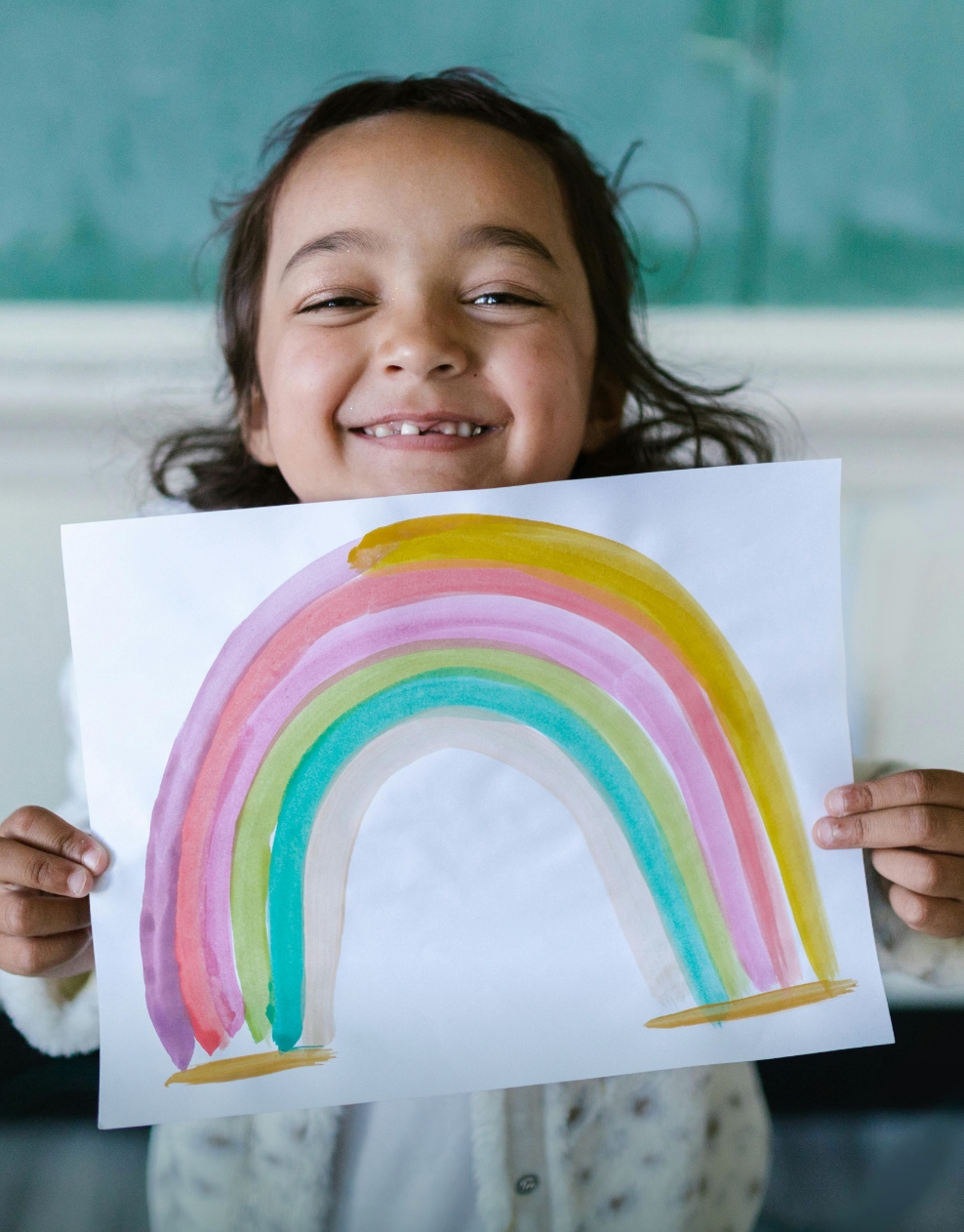 A young girl enjoying a quiet moment in nature, smelling flowers during Tot’s Recharge in Hayling Island.
