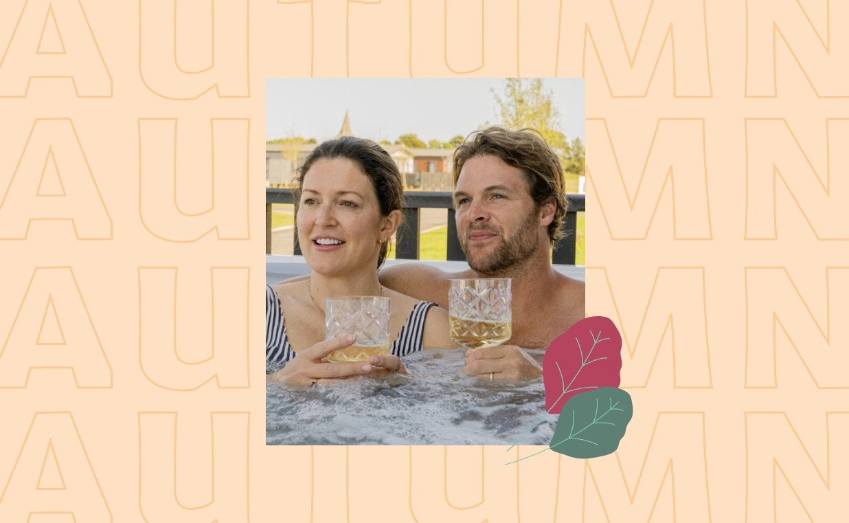 A couple relaxing in a hot tub with drinks at Hayling Island during autumn.