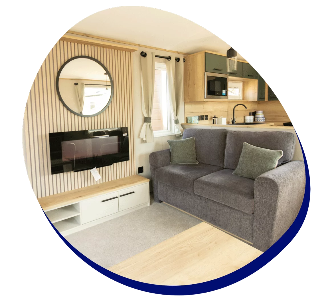 Holiday home living area with sofa and fireplace promoting pitch fees freeze at Hayling Island