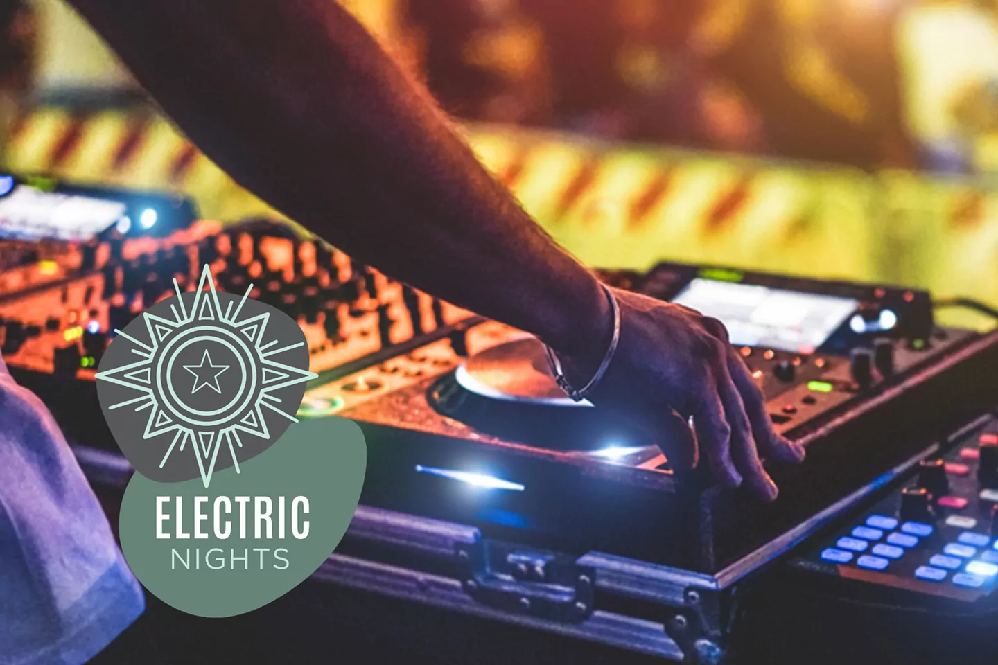 DJ mixing music on a professional controller during the Electric Nights entertainment event at a holiday park on Hayling Island.