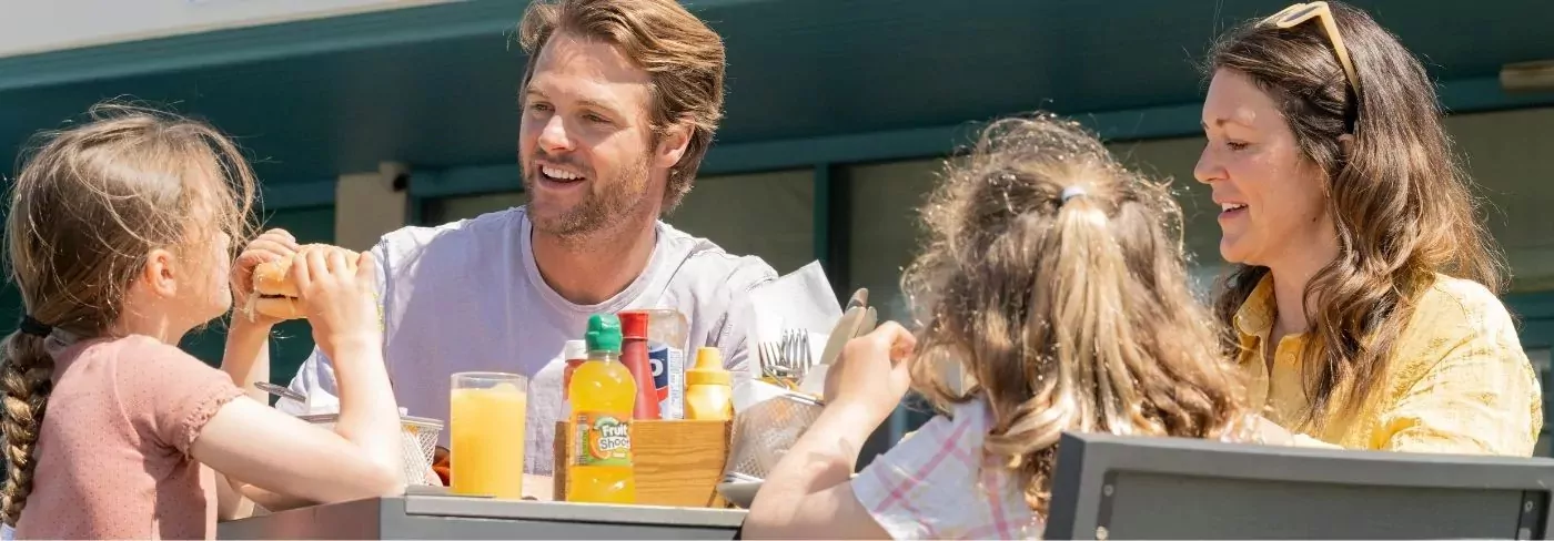 A family enjoying an outdoor meal together on a sunny day at Hayling Island.