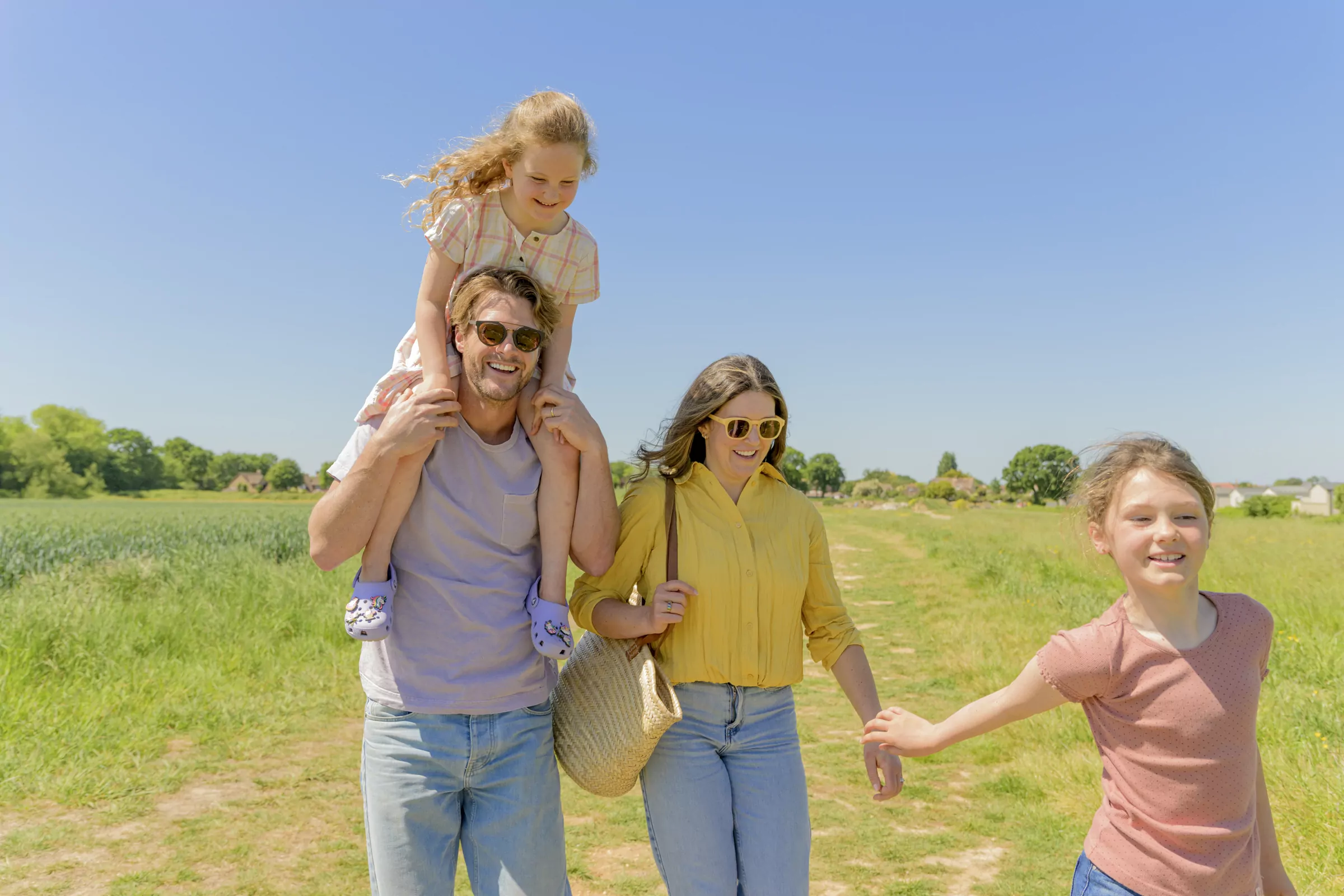 Family happily walking through a field