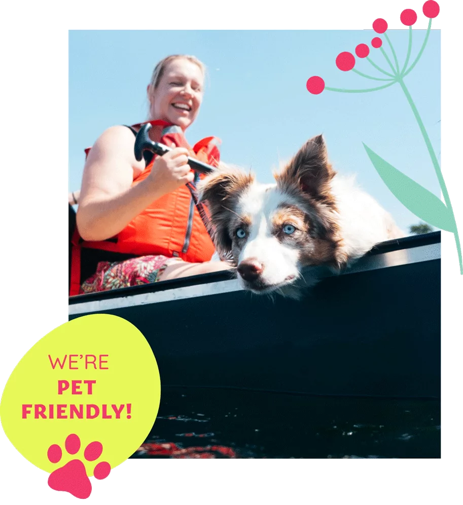 Woman paddling a canoe with her happy dog beside her, both enjoying a sunny day on the water, with pet-friendly badge