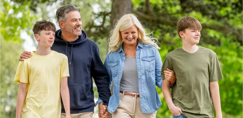 Family enjoying a relaxed walk together through green outdoor surroundings at Meadow Bay Villages