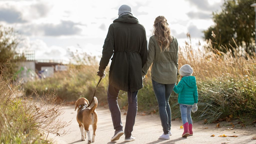 Family Walking Their Dog on a Weekend Break