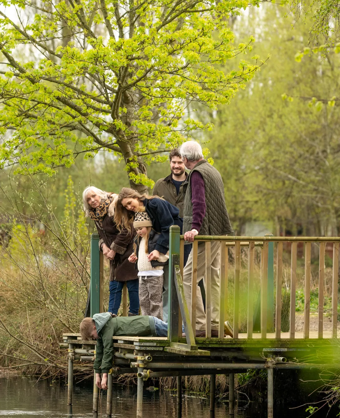 Multi-generational family enjoying a peaceful nature walk by the lake at Billing Aquadrome.