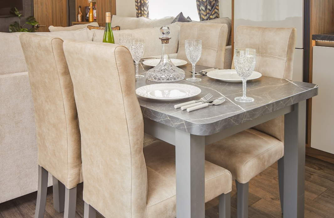 Stylish dining area with upholstered seating and table settings at Meadow Bay Villages