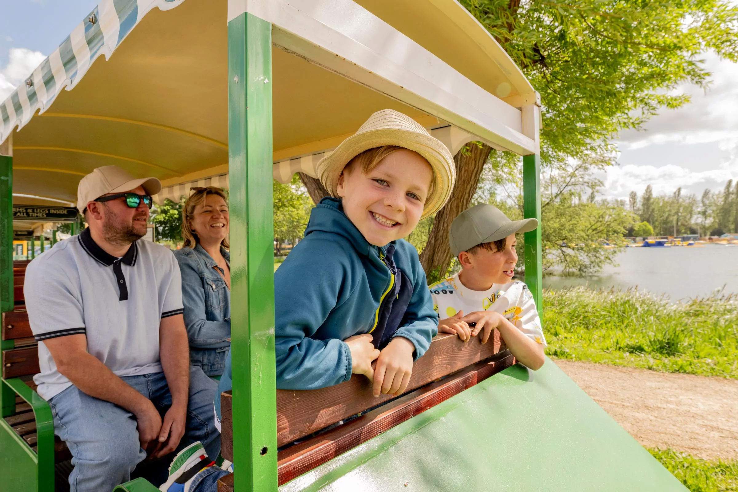 Family enjoying a scenic train ride around Meadow Bay Villages, perfect for sightseeing and relaxing with kids.