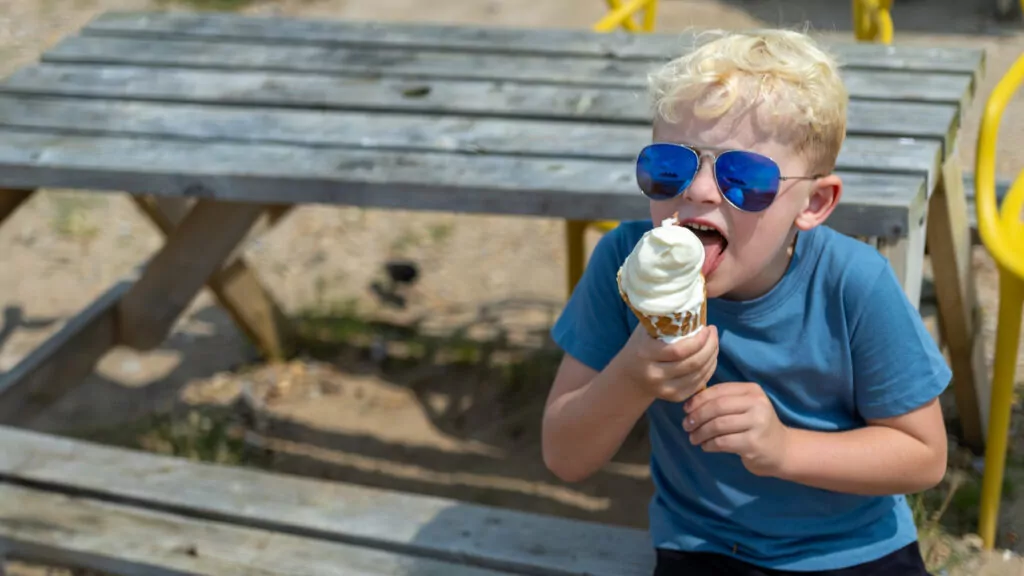 Little boy enjoying an ice cream at Hayling Island Beach